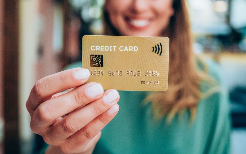 woman-holding-a-credit-card-royalty-free-image-1580915622.jpg